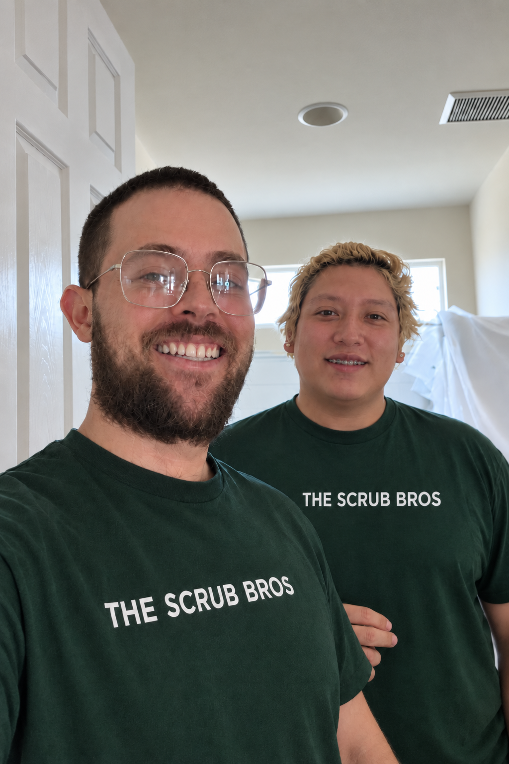 Iker Hassey, owner of Scrub Bros, with a team member on a job site