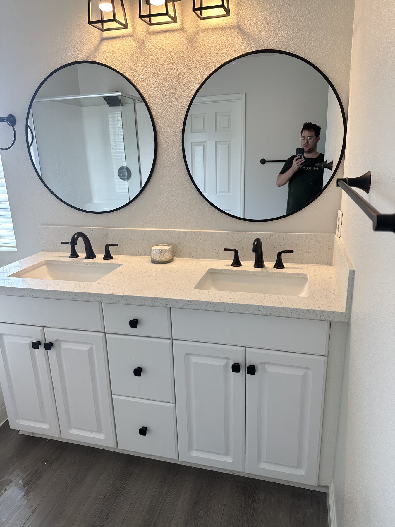 Double bathroom vanity with round mirrors and streak-free quartz counter after a Scrub Bros clean